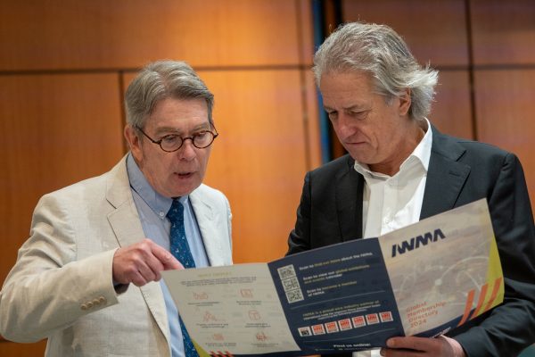 IWMA Chairman reading though the IWMA membership directory designed by Chase Creative